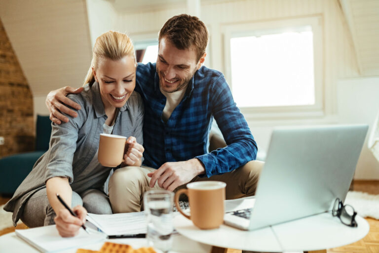 Homeowners refinancing their Texas mortgage online and enjoying coffee.