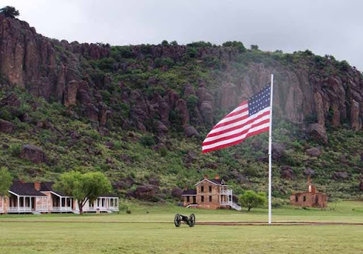 American flag waving in the Davis Mountains of Fort Davis, Texas, symbolizing community pride, rural living, and affordable Fort Davis home loans and mortgage options.