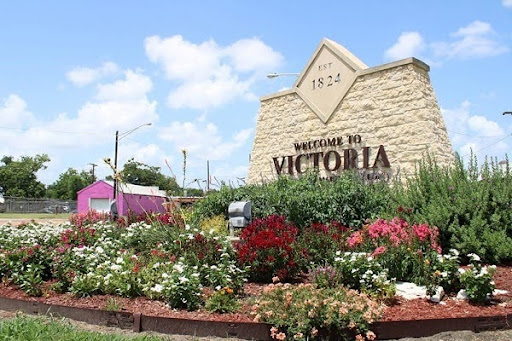 Welcome sign surrounded by flowers in Victoria, Texas, promoting Victoria Texas Home Loans and community living.