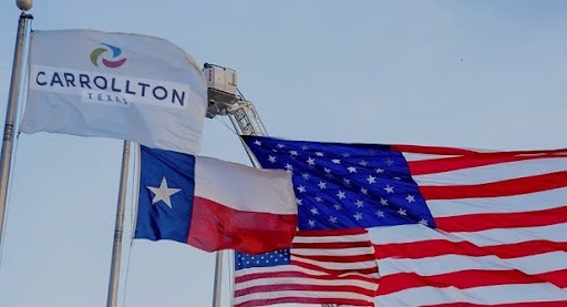 Flags representing Carrollton, Texas, the State of Texas, and the United States waving together under a clear sky — symbolizing community pride, stability, and opportunity for homeowners seeking Carrollton, Texas home loans and mortgage refinancing.