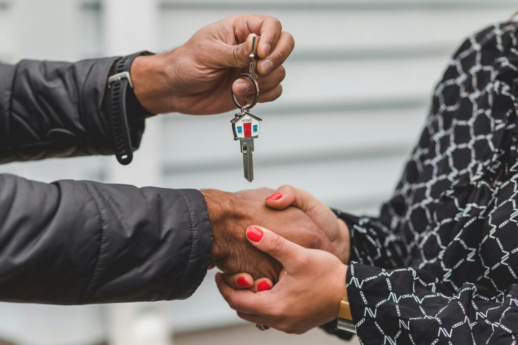 Loan officer handing keys to happy borrowers | Copperas Cove Texas home loans and mortgage closing