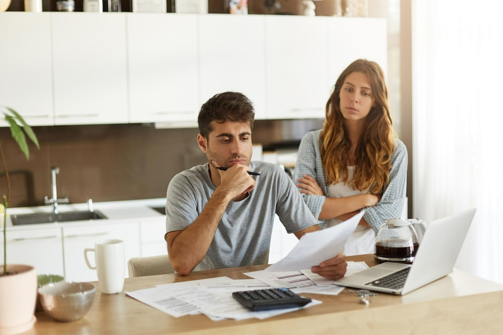 Couple reviewing finances while comparing Conventional vs FHA Loan in Texas