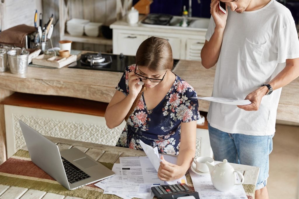 Couple reviewing finances at home for Allen down payment assistance.