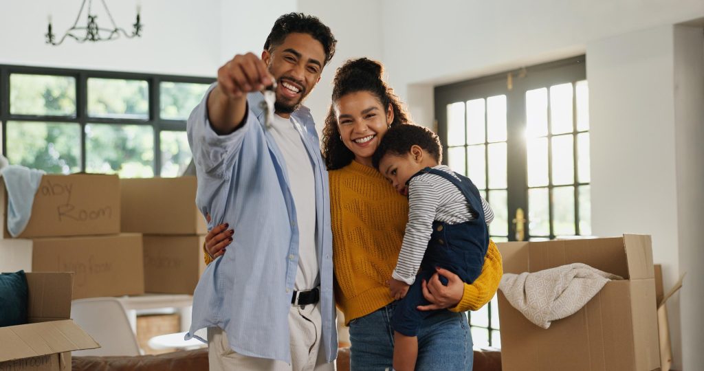 Spanish-speaking family holding new home keys after a successful home purchase with mortgage guidance in Texas