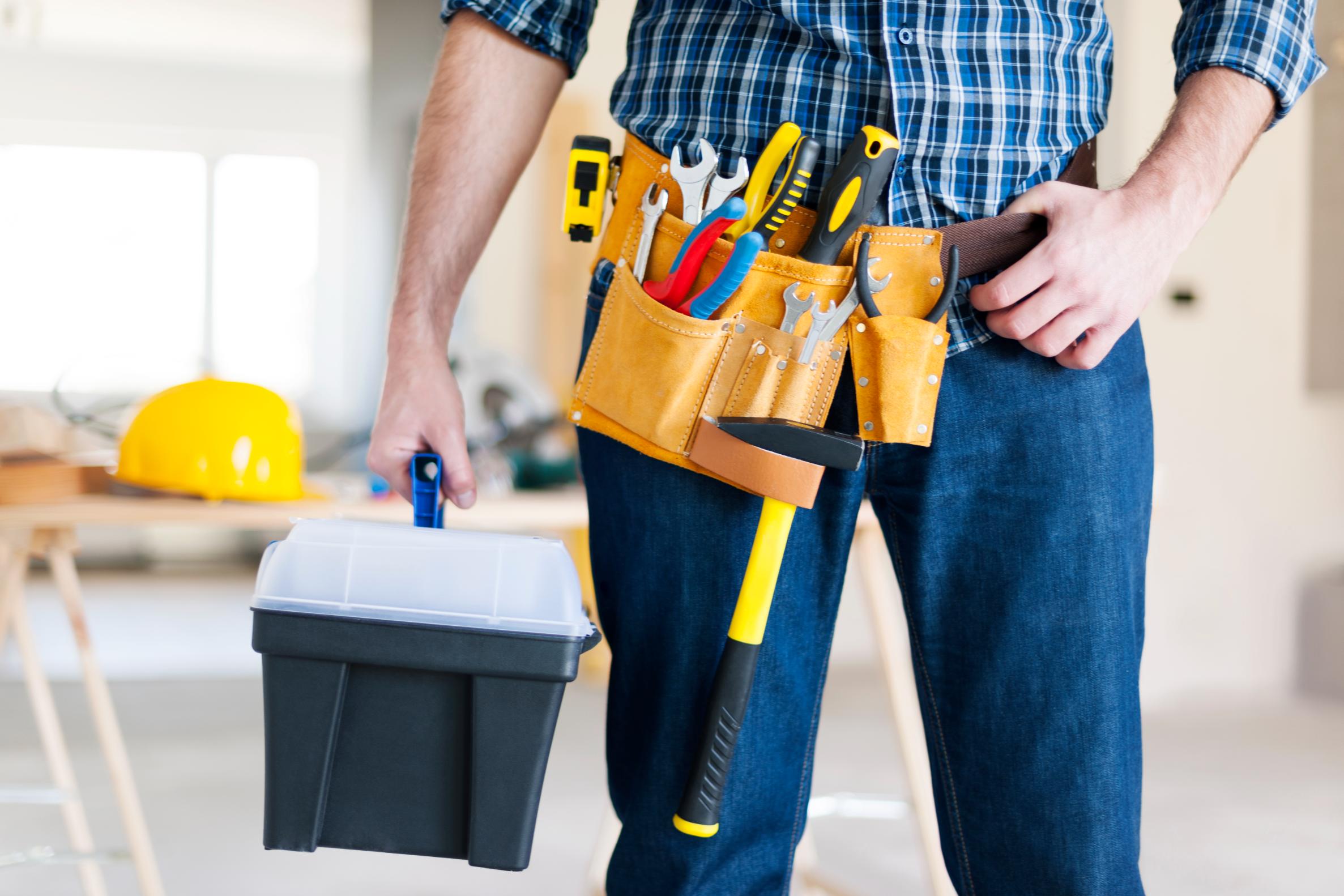 Contractor holding tools and toolbox during a home improvement project funded through home renovation financing in Texas.