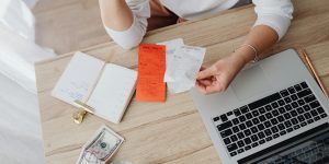 Homeowner reviewing financial documents and expenses while considering jumbo home loans for high-value property financing.