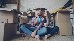 Couple moving into new house celebrating first-time homebuyer in Texas journey with mortgage approval and new home excitement.