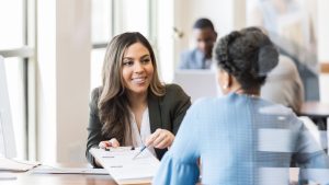 Mortgage advisor explaining Non-QM loan options to a homebuyer during a personalized financing consultation.